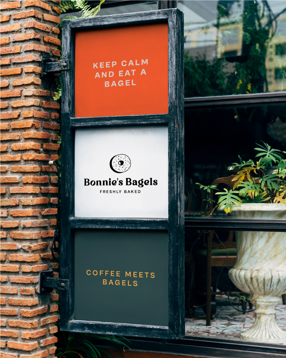 OUTDOOR POSTER outdoor poster image with three images, above orange with the phrase keep calm and eat a bagel, in the middle white image with bonnie's bagel logo in the center