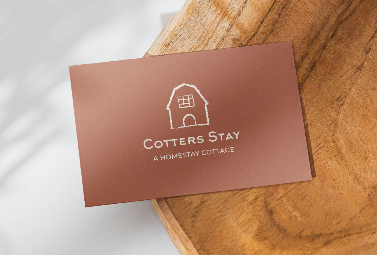 brown card with Cotter Stay logo in center