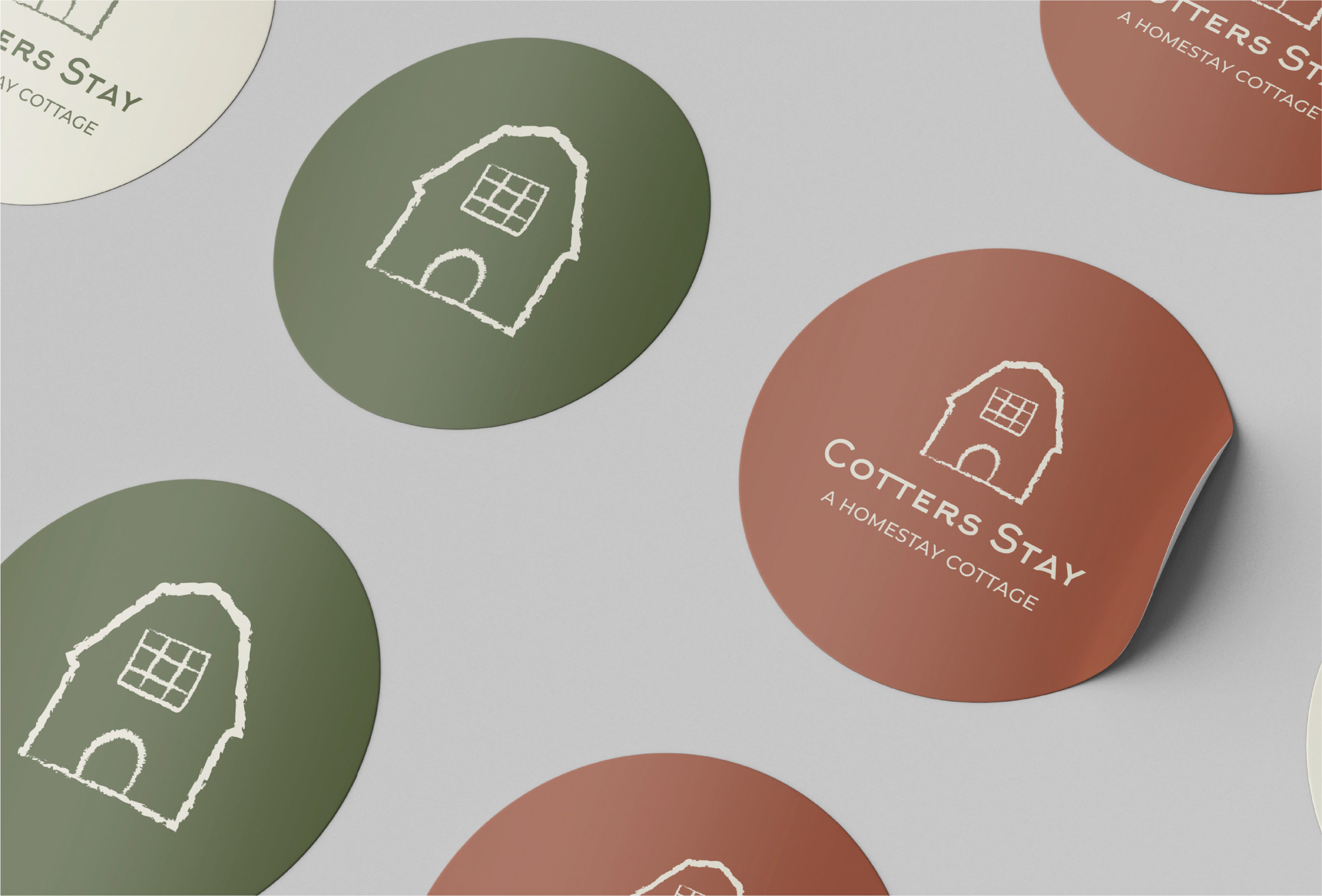 GREEN AND BROWN STICKERS Image of green and brown circular stickers with Cotters stay logo in the center
