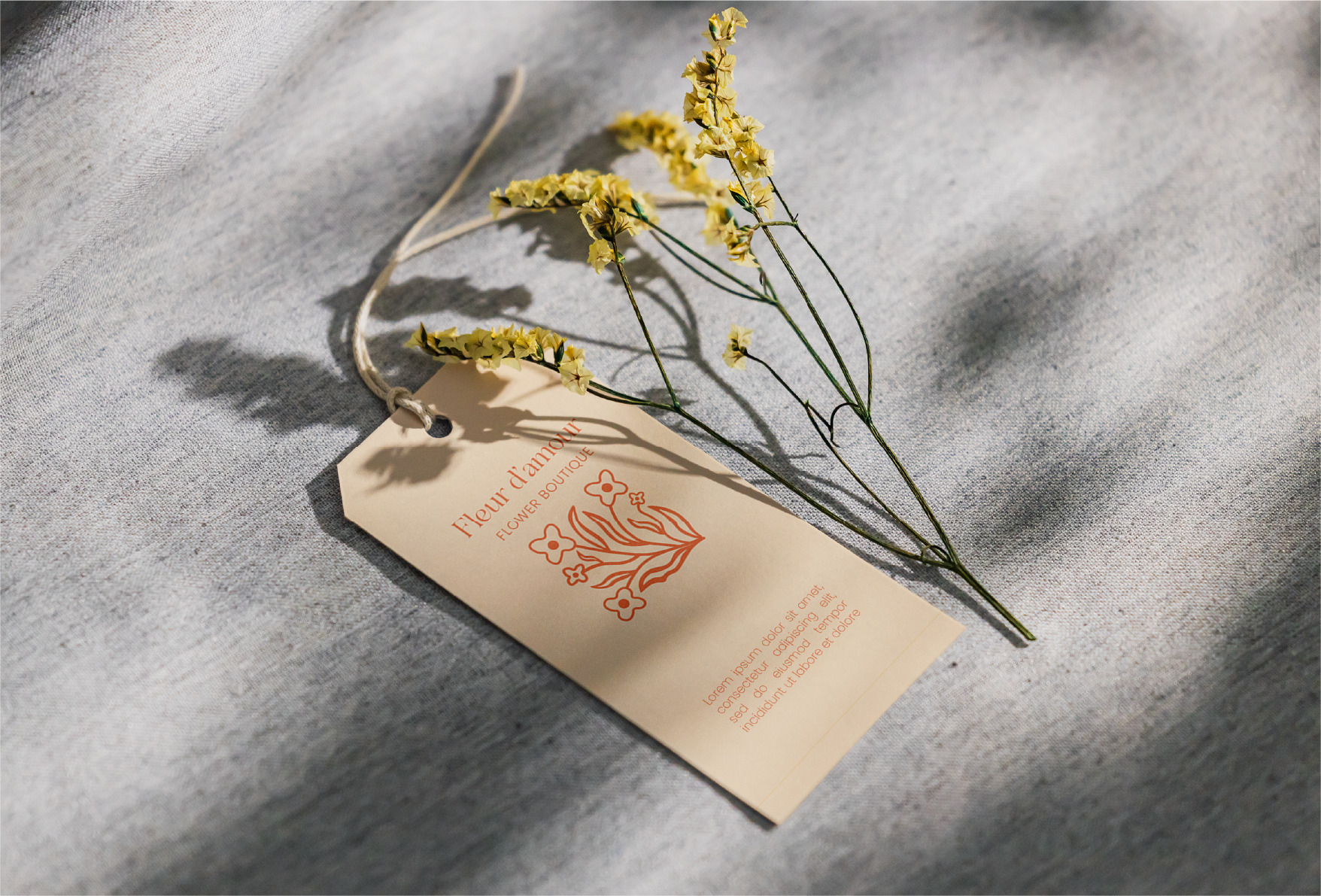 CLOTHING LABEL image of cream-colored clothing label with Fleur logo in the center