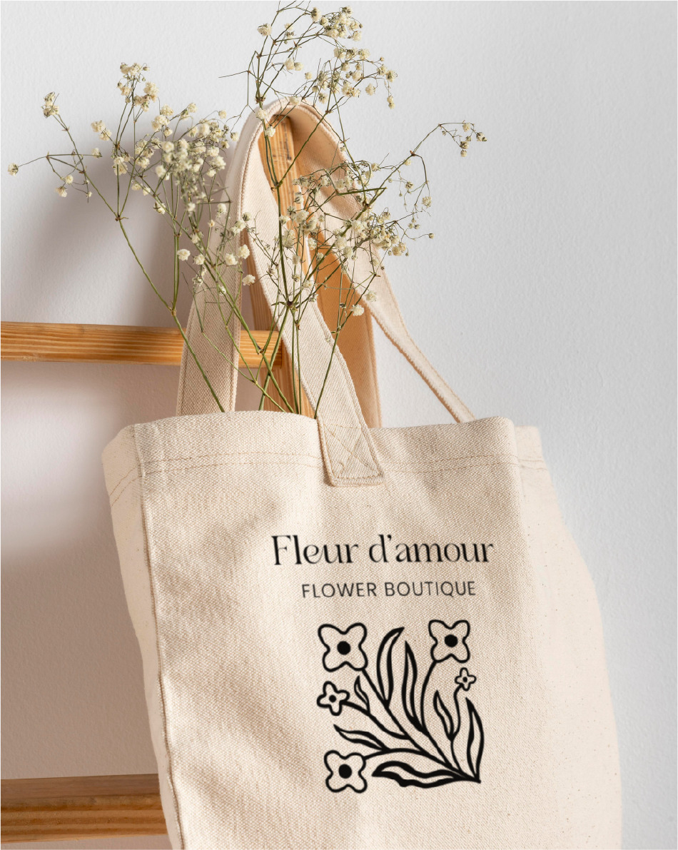 HANGING BAG image of hanging tote bag with flowers and fleur d'amour logo in the center